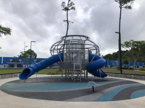 a playground with a blue slide in a park at Chill-out @ SiRaM-MaRiS, Desaru (5 mins to beach) in Bandar Penawar