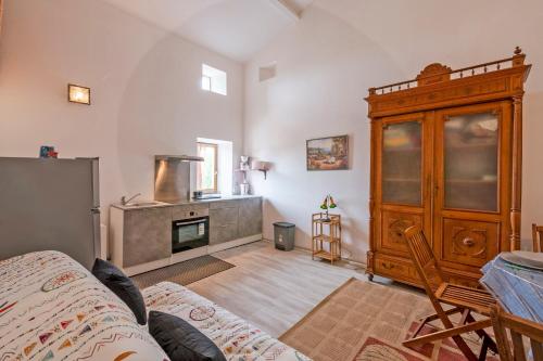 a living room with a wooden cabinet and a fireplace at Mazet Tornac in Tornac