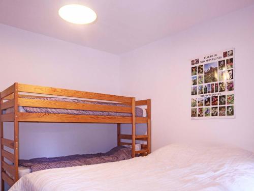 a bedroom with two bunk beds and a poster on the wall at Appartement Les Orres, 2 pièces, 6 personnes - FR-1-322-218 in Les Orres
