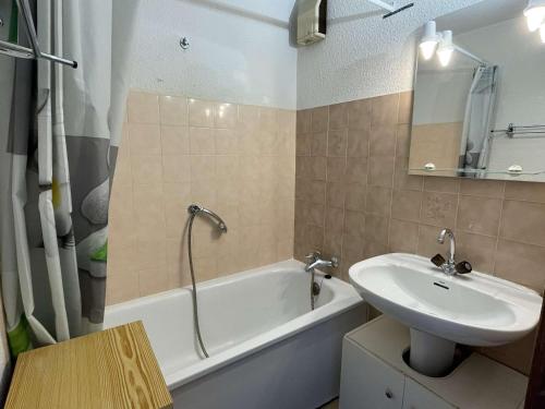 a bathroom with a sink and a bath tub and a sink at Appartement Praz-sur-Arly, 2 pièces, 4 personnes - FR-1-603-39 in Praz-sur-Arly