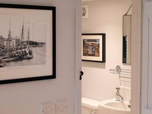 a bathroom with a sink and a picture on the wall at Studio at Church House in Bideford