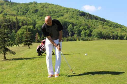 a man is playing golf on a field at Penzion Roubenka in Hukvaldy