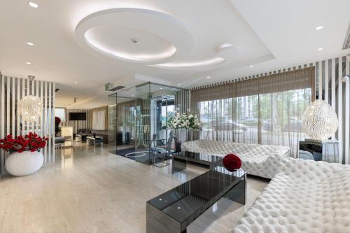 a living room with a white couch and a table at Hotel 9 in Zagreb