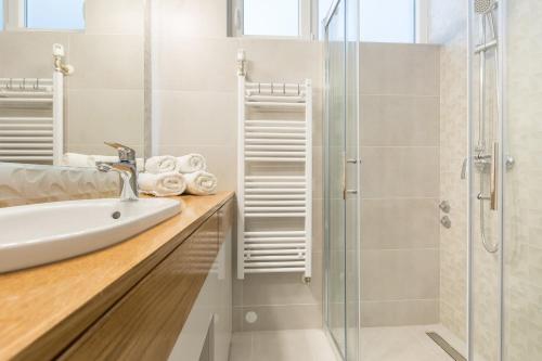 a bathroom with a sink and a shower at Miramare in Zagreb