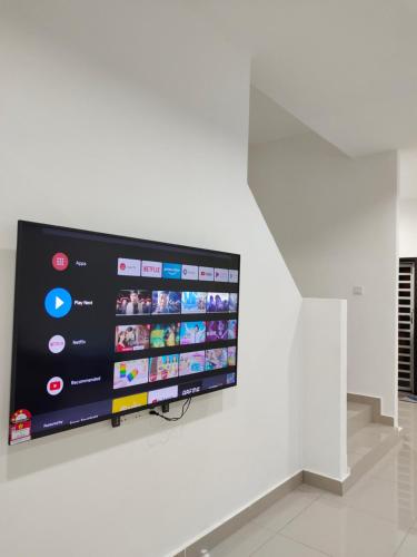 a large flat screen tv hanging on a wall at V-Homestay Bentong in Bentong