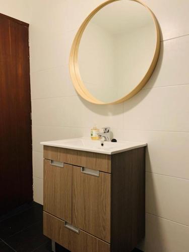 a bathroom with a sink and a mirror on the wall at Grandma's Carolina Villa in Sul