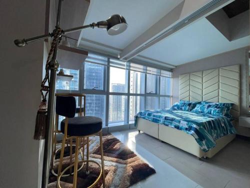 a bedroom with a bed and a floor to ceiling window at Stylish 1BR Uptown Parksuites BGC, 200mbps/SmartTv in Manila