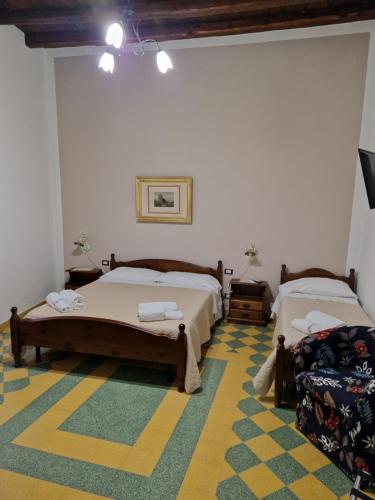 a bedroom with two beds and a yellow carpet at I Tetti di Girgenti in Agrigento
