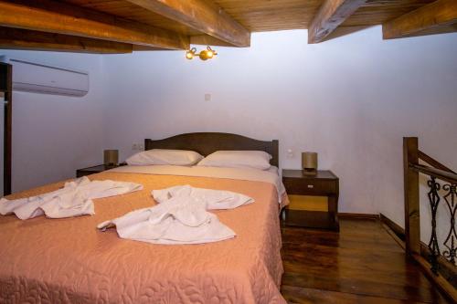 a bedroom with a bed with towels on it at Christina Apartments 2 in Drapaniás