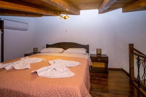 a bedroom with a bed with towels on it at Filoxenia 2 in Drapaniás