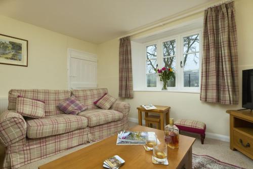 a living room with a couch and a table at 2 Lower Spire in Dulverton