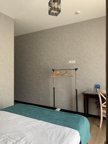 a bedroom with a bed and a table with aitivity at Hotel GENI Kazbegi in Stepantsminda