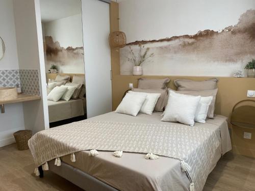 a bedroom with a large bed with white pillows at Luxe & Confort, Spacieux, Neuf, Clim et Central in Sète