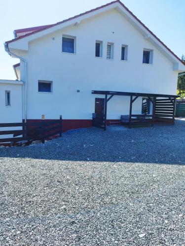 a large white building with a large driveway at Holling apartman in Fertőboz
