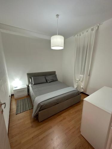 a small bedroom with a bed and a window at Villa Mariuccia in Siracusa