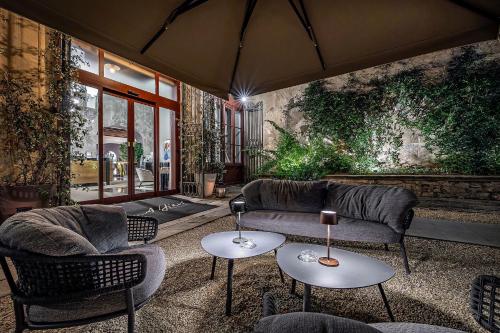 a living room with two couches and two tables at Il Rivalta - Place of Charme in Florence