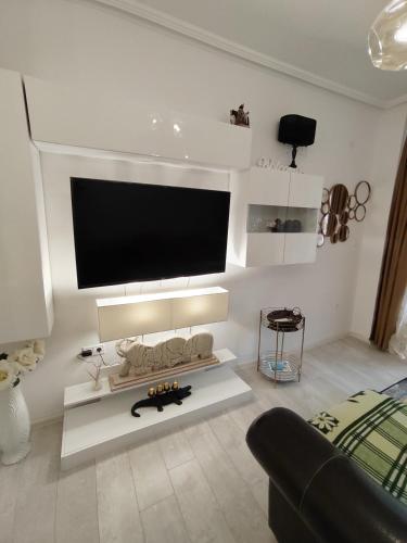 a living room with a flat screen tv on the wall at Gold Infinity in Velingrad
