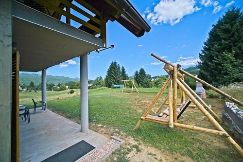 a large yard with a swing set on the grass at House Andrija in Jasenak