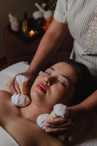 a woman is getting an ice cream massage at The Ritz-Carlton, Bangalore in Bengaluru