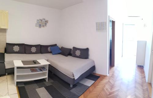 a living room with a bed and a table at Apartmani Rudelj in Makarska