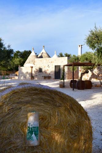 a large pile of hay in front of a building at Trulli di Titti - Luxury Country House in Castellana Grotte