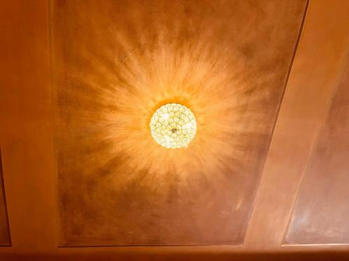 a ceiling with a light in the middle of a room at Casa Nina Bologna Centro in Bologna