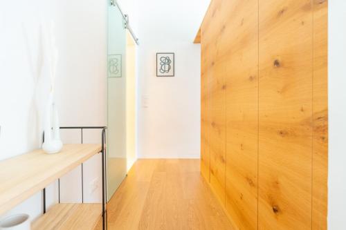 una puerta giratoria en una habitación con una pared de madera en Cozy-City Appartement, en Krems an der Donau