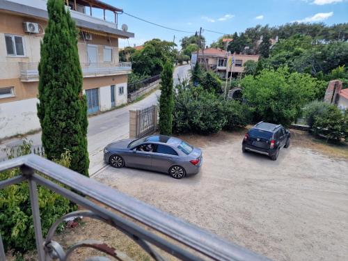 two cars parked in a parking lot next to a building at Valia's house -Makri Village in Mákri