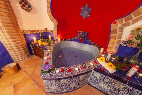 a bathroom with a tub with candles in it at Casas Cueva Cazorla in Hinojares