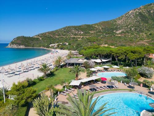 an aerial view of a resort with a pool and beach at Cormoran Residence in Villasimius