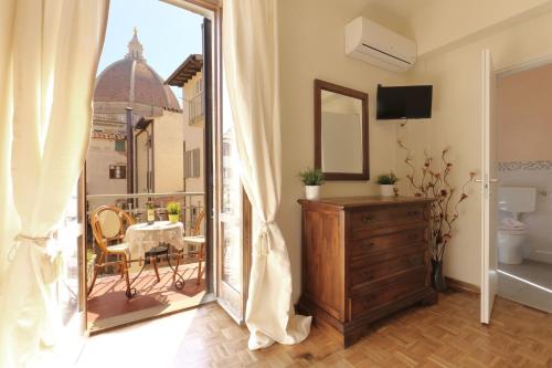 Habitación con balcón con tocador y espejo. en Guesthouse Bel Duomo, en Florencia