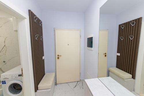 a bathroom with a washing machine and a washer and dryer at Luxury Villa 4 in Vlorë