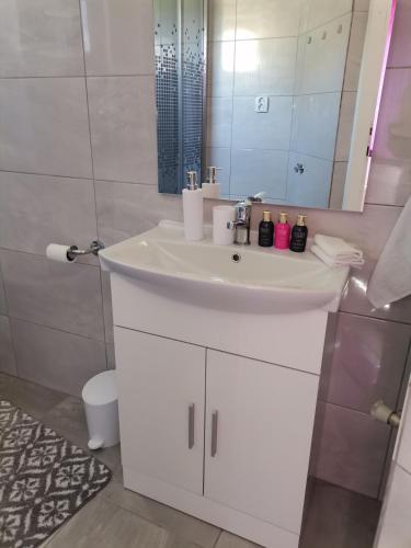 a bathroom with a white sink and a mirror at Lucija in Gospić