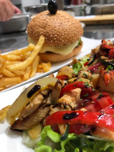 a plate of food with a hamburger and french fries at Šangulin Palace M in Biograd na Moru