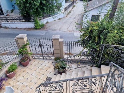 a wrought iron staircase with potted plants on a street at Valia's house -Makri Village in Mákri