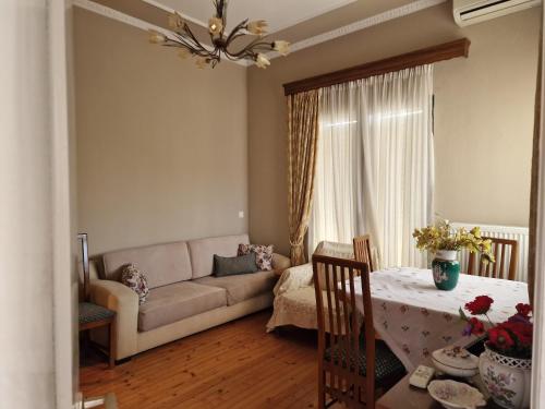 a living room with a couch and a table at Valia's house -Makri Village in Mákri