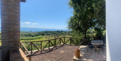 a balcony with a table and a view of a field at Casa laggiù in Gradoli