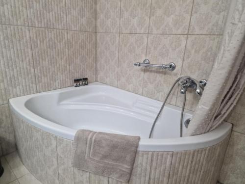 a bath tub in a bathroom with a towel at Valia's house -Makri Village in Mákri