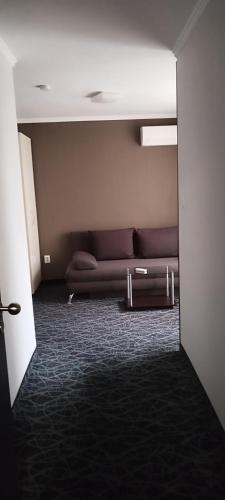 a living room with a couch in a room at Hotel Perfect in Varna City