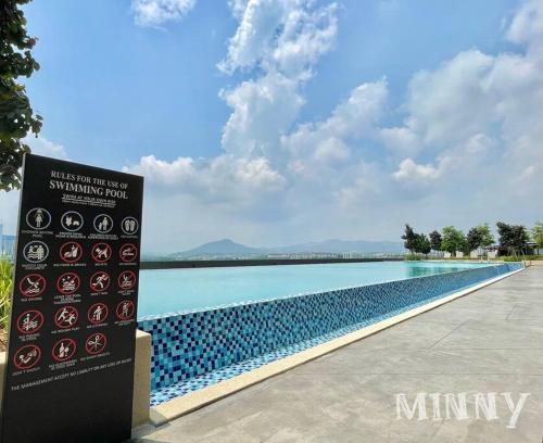 a sign in front of a swimming pool with water at Netizen near MRT Balcony View in Cheras