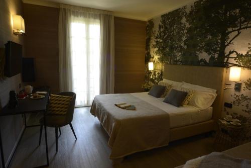 a hotel room with a large bed and a desk at Hotel Villa Cappugi in Pistoia