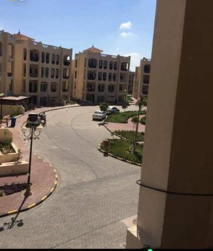 an empty street in a city with tall buildings at شاليه قريه فارما بيتش ريزورت in Al Ḩammād