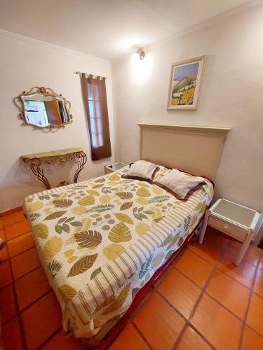 a bedroom with a bed and a tv on the wall at Cabañas Del Sauce in Paraná