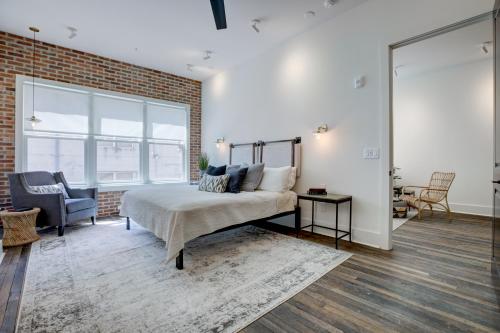 a bedroom with a bed and a brick wall at New Construction Loft Style Spacious Lux Apt in Atlanta