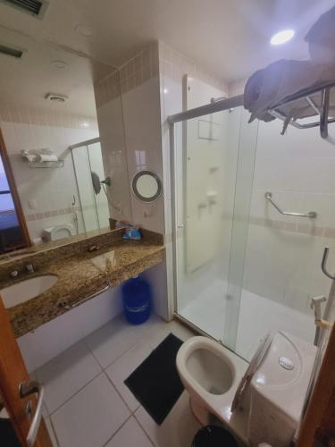a bathroom with a shower and a toilet and a sink at Tropical Executive Vista Maravilhosa in Manaus