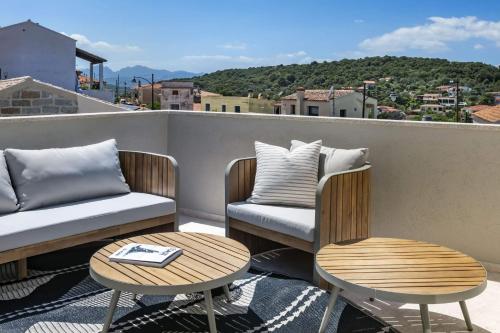 a couple of chairs and tables on a balcony at Borgo Antico San Pantaleo in San Pantaleo