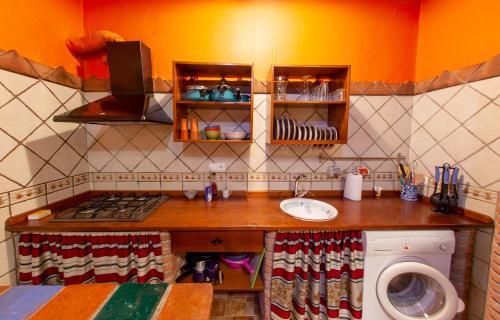 a kitchen with a sink and a stove top oven at Casas Cueva Cazorla in Hinojares