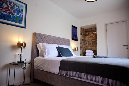 a bedroom with a large bed with white pillows at Vacation house Rubi in Dubrovnik