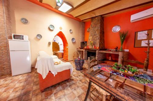 a living room with a refrigerator and a fireplace at Casas Cueva Cazorla in Hinojares