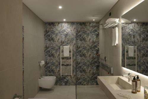 a bathroom with a toilet and a sink and a shower at Hotel Villa Cappugi in Pistoia